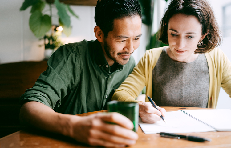 a couple filling in a document